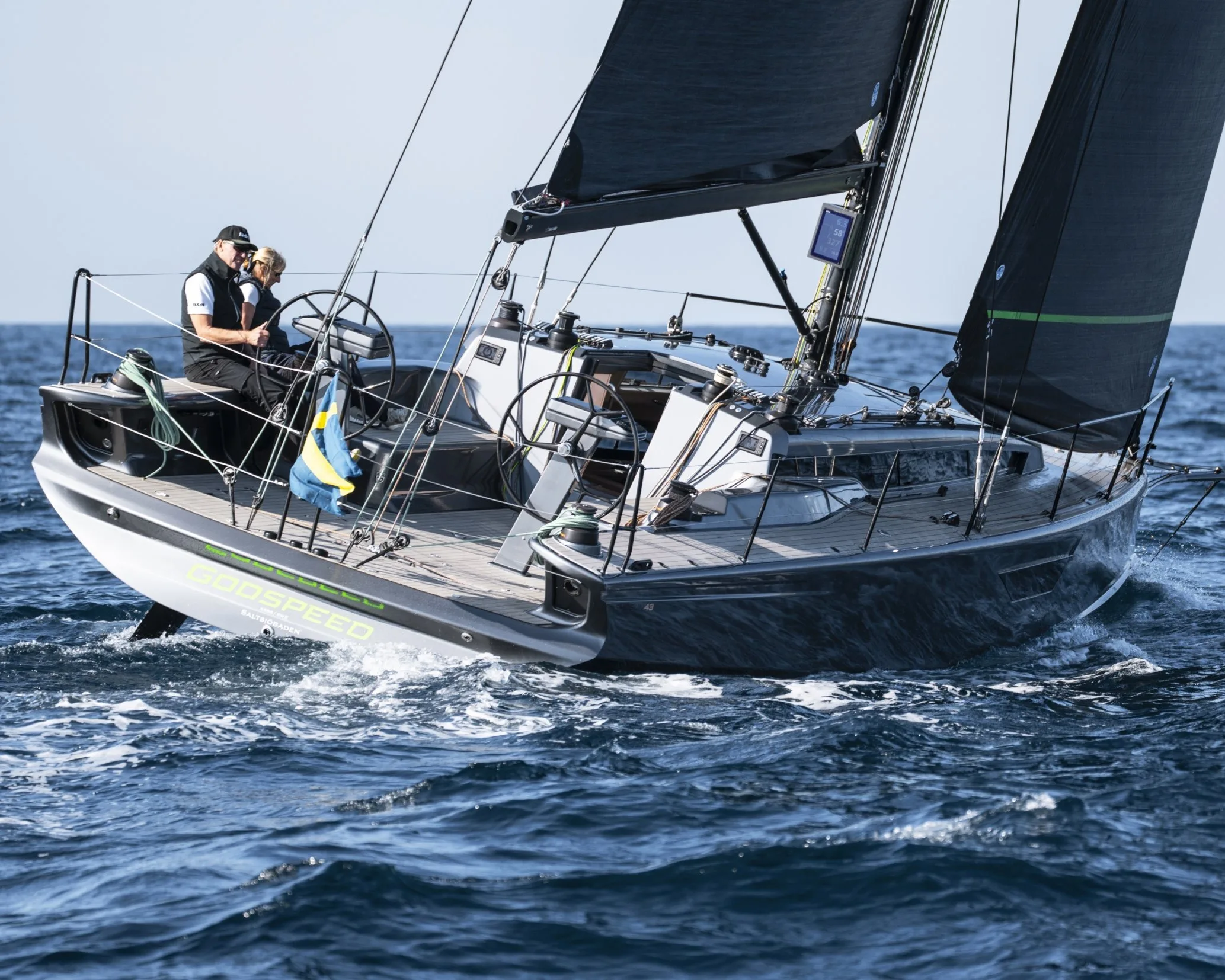 Two sailors working the Shogun 43 cockpit in offshore conditions