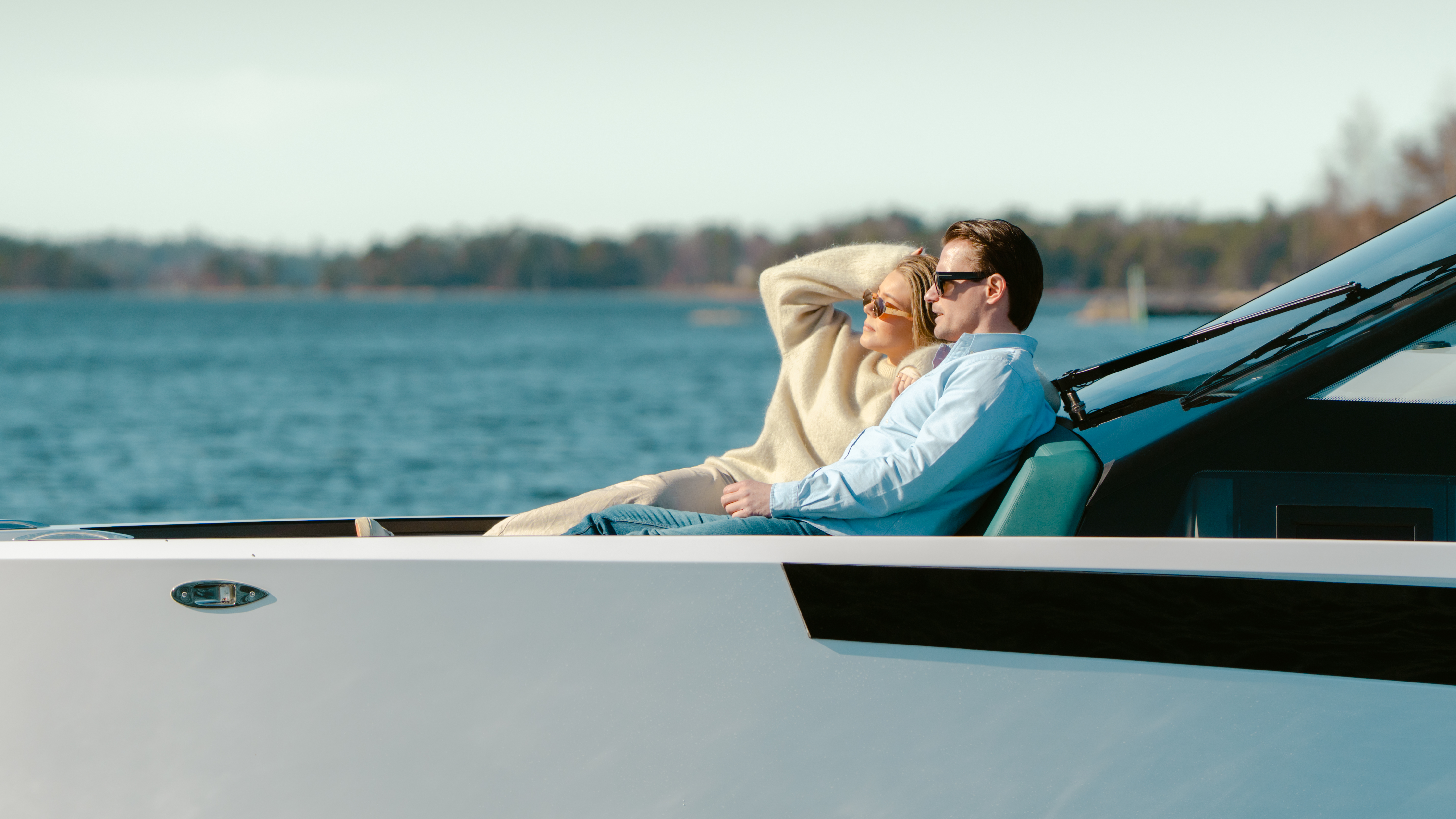 Guests relaxing on the foredeck of a Virtue Yachts V10 Cabin at anchor.
