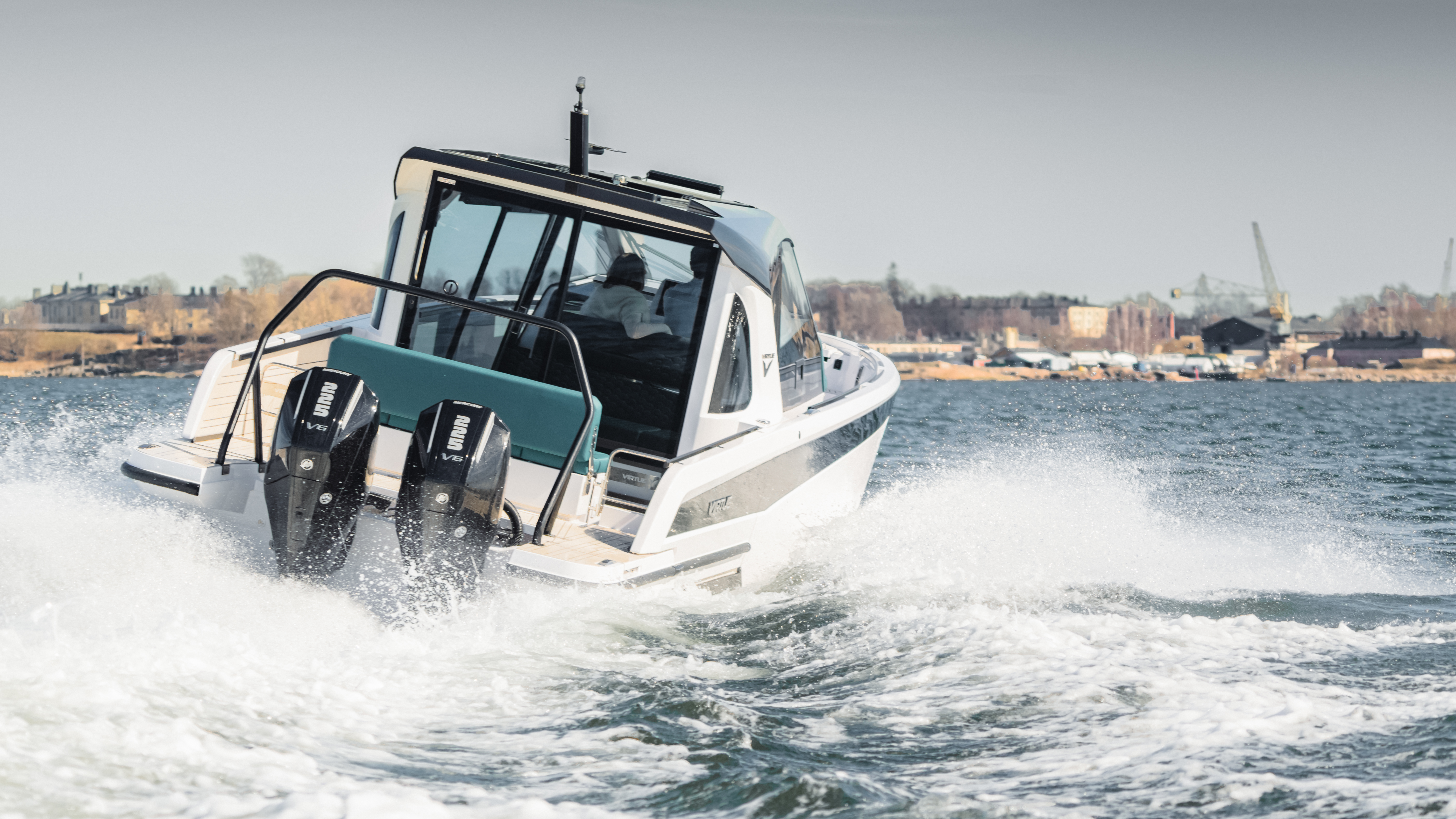 Virtue Yachts V10 Cabin underway, stern quarter view with twin outboards.