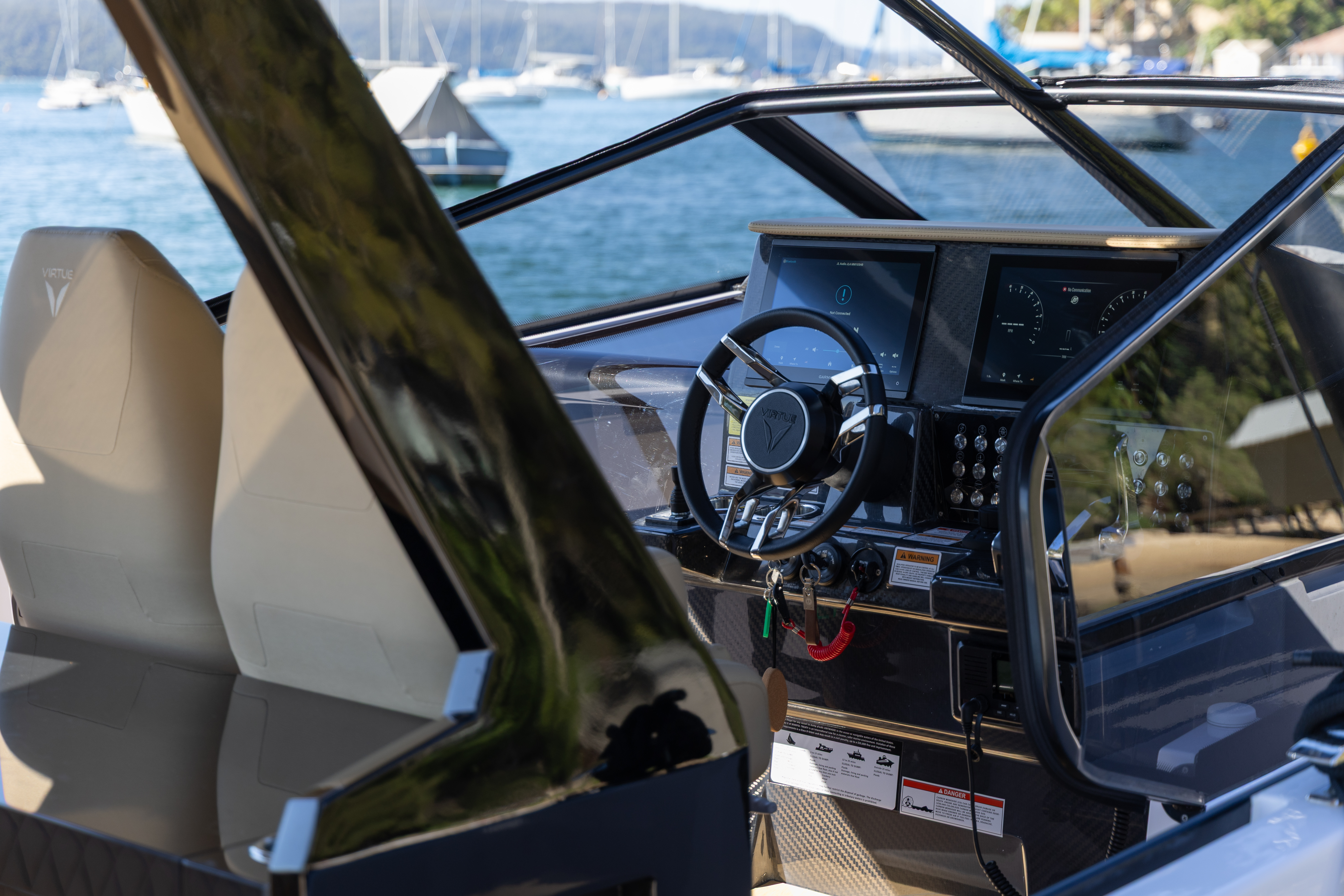 Virtue Yachts V10 helm station with suspension seats and steering wheel.